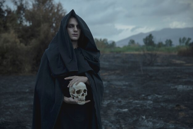 Skull being held by male mage in black clothes