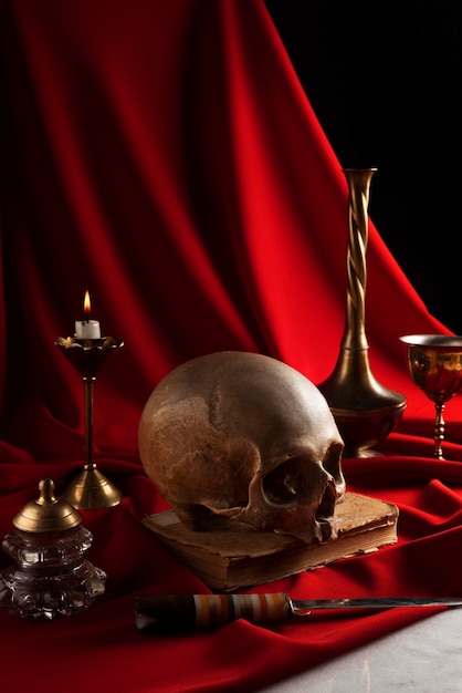 Free photo skull and candle arrangement still life