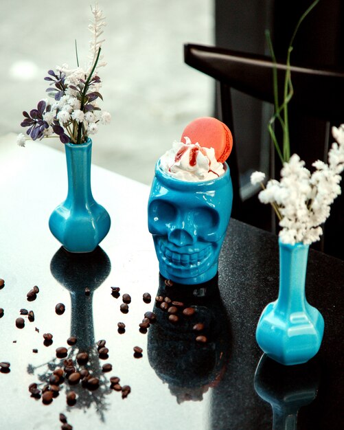 Skull cup with cream and macaroon