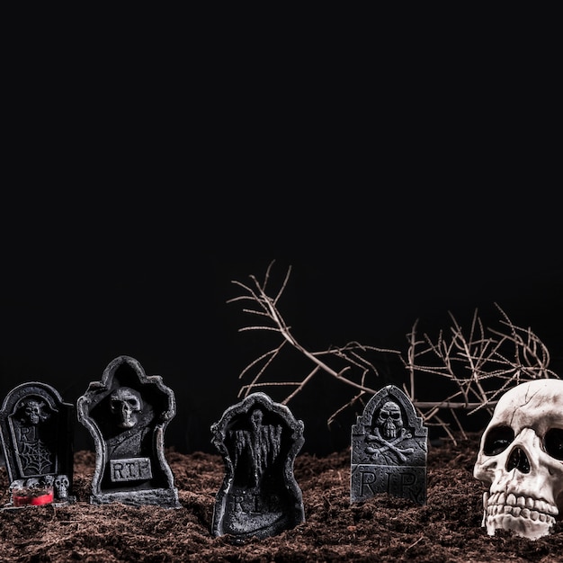 Skull and tombstones on night cemetery