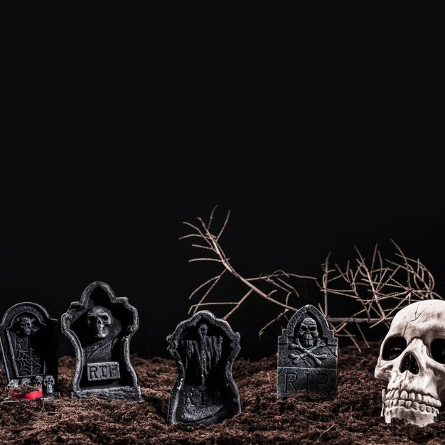 Skull and tombstones on night cemetery