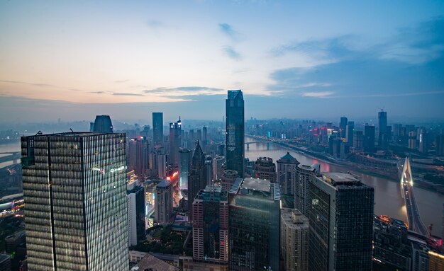 skyline and landscape of chongqing at riverbank during sunrise.