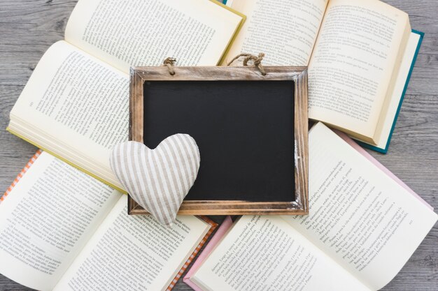 Slate and heart on open books