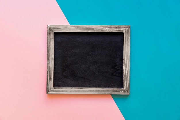 Free photo slate on pink and blue background