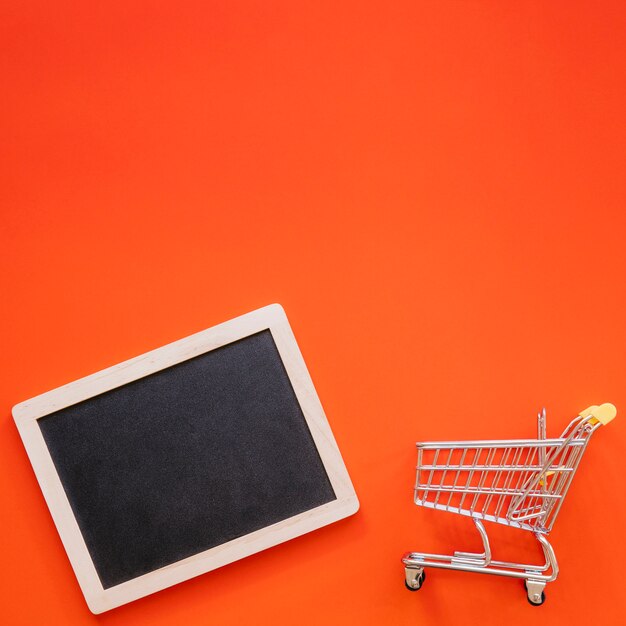 Slate next to small shopping cart