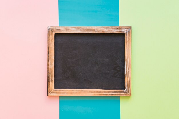 Slate with wooden border on colorful background