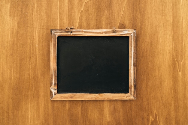 Free photo slate on wooden texture