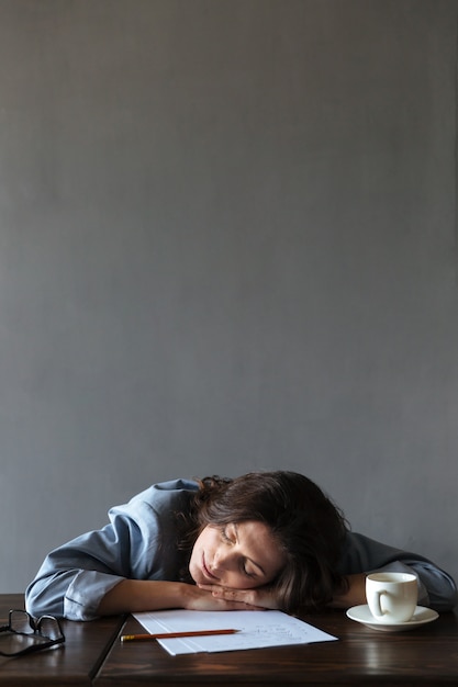 Free photo sleeping woman writer lies indoors