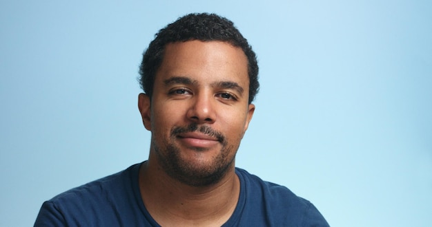 Sleepy mixed race man portrait on a deep blue background