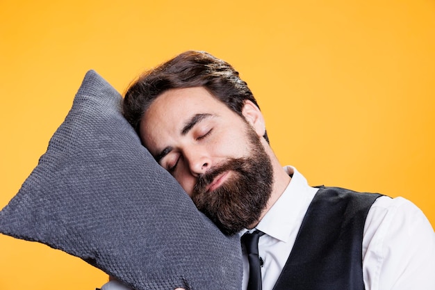 Free photo sleepy waiter using pillow to take nap