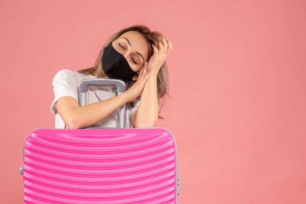 Sleepy young woman with black mask