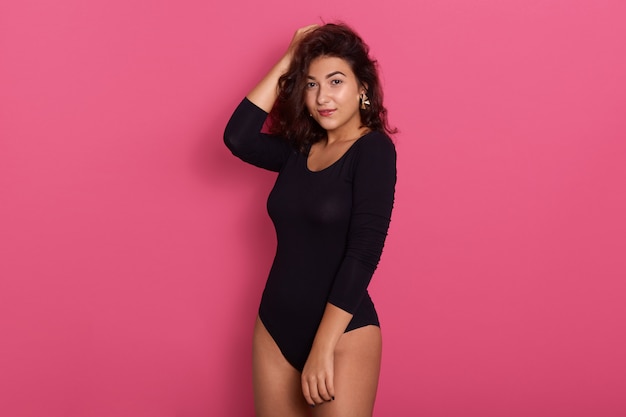 Slender and young girl with beautiful and fit body wearing black bodysuit