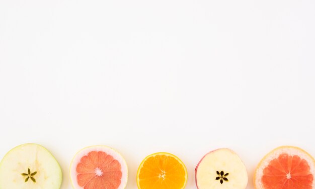 Slice of apple; grapefruit and orange slice isolated on whit backdrop with copy space for writing the text