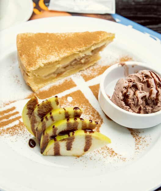 A slice of apple pie with chocolate ice cream, cinnamon on the top. 