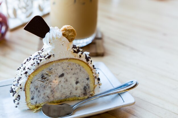 Slice of cake with ice cream and coffee