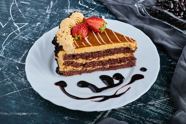 A slice of caramel cake with berries. 