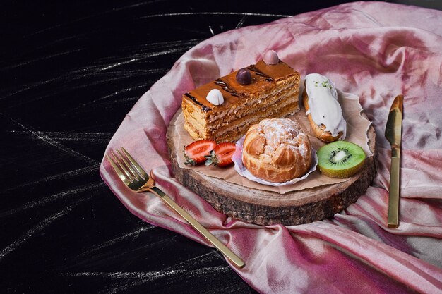 Slice of caramel cake on a wooden platter .