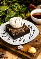 Free photo a slice of chocolate brownie with walnut and vanilla ice cream