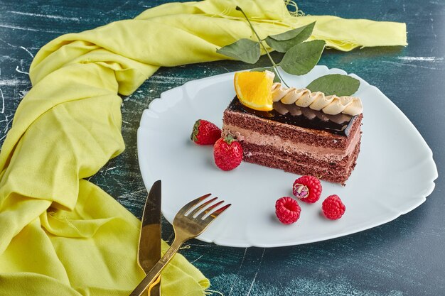 A slice of chocolate cake in a white plate. 