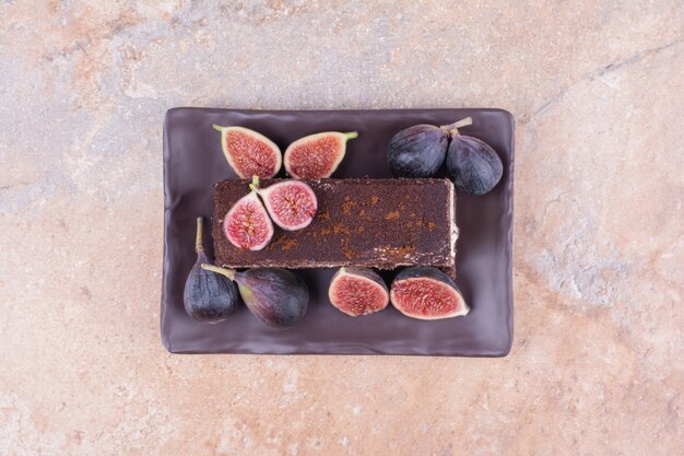 A slice of chocolate cake with figs and cornels
