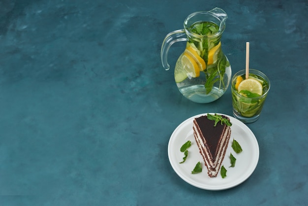 A slice of chocolate cake with mojito, top view.