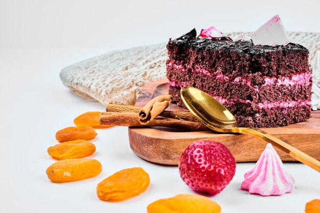 A slice of chocolate caramel cake with strawberry cream.