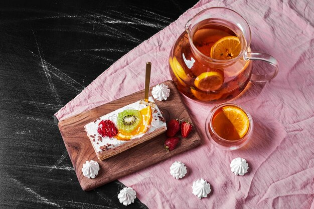 Slice of fruit cake on wooden platter .