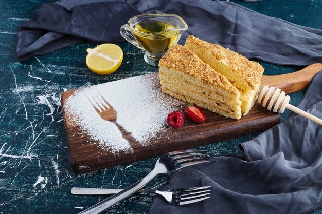 A slice of honey cake on a wooden board. 