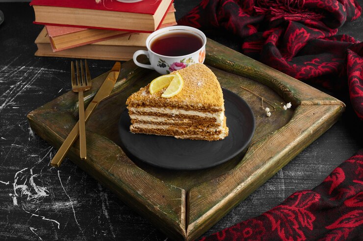 Free Photo a slice of medovic cake with lemon and tea. 