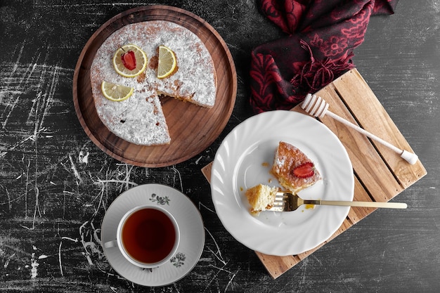 A slice of pie with a cup of tea, top view. 