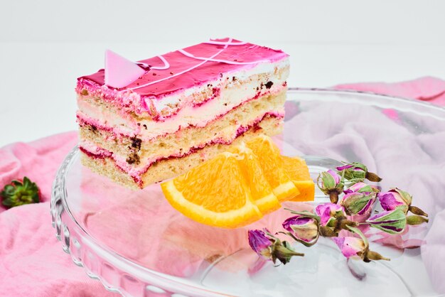 A slice of raspberry cake with oranges.
