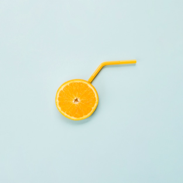 Slice of ripe orange citrus and straw 