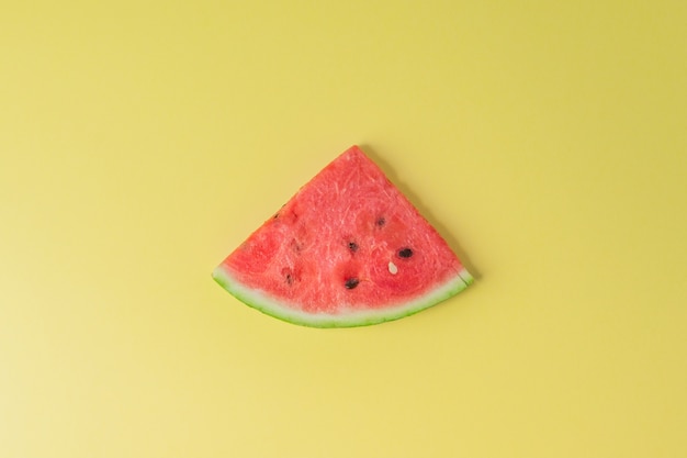 Slice of watermelon on yellow background