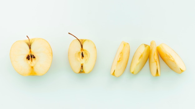Sliced apples on pale blue background