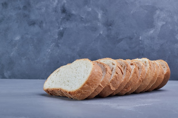 Sliced bread on blue table.