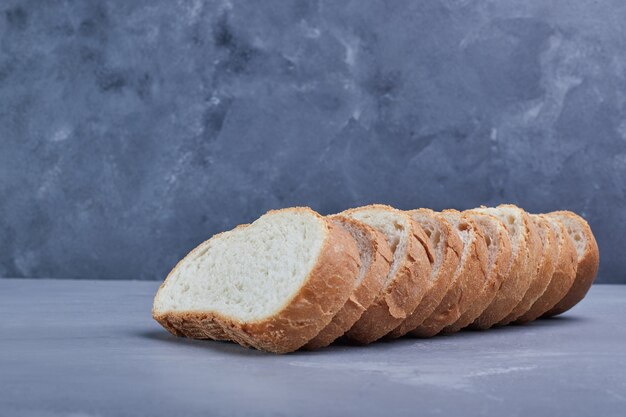 Sliced bread on blue table.
