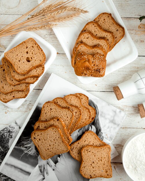 Sliced bread and  wheat branch on the table