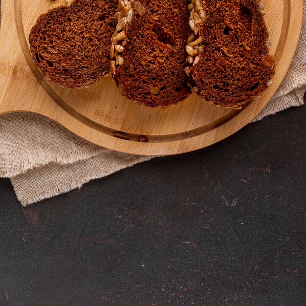 Sliced of bread on wooden background with cloth