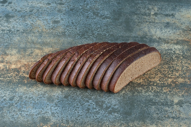 Sliced brown bread on marble background