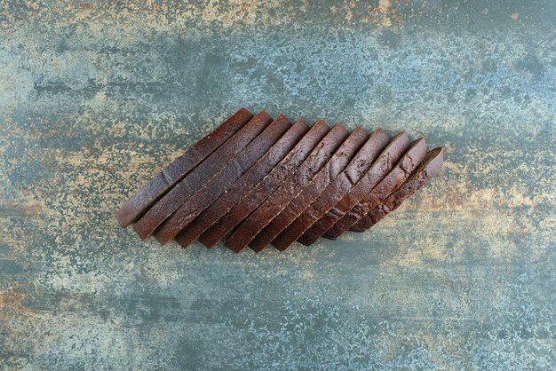 Sliced brown bread on marble background