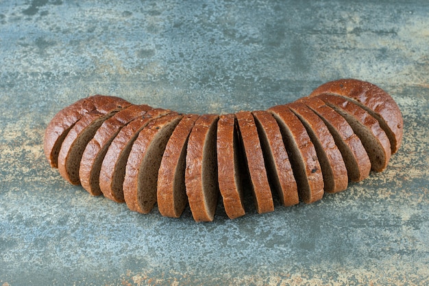 Sliced brown bread on marble background