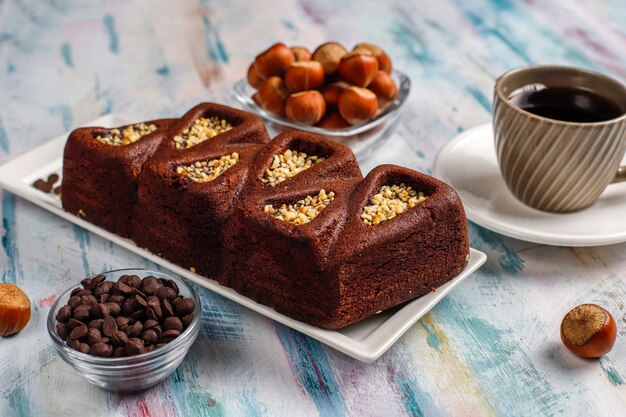 Sliced brownie cake with hazelnuts.