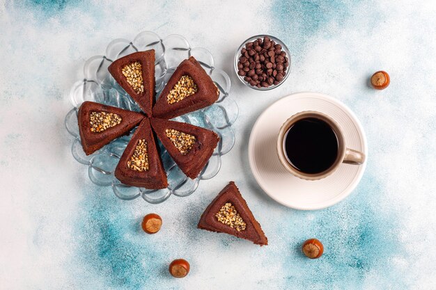 Sliced brownie cake with hazelnuts.