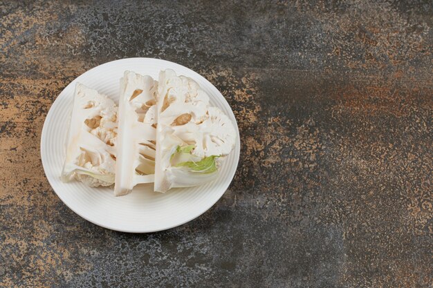 Sliced cauliflower arrangement on plate, on the marble surface