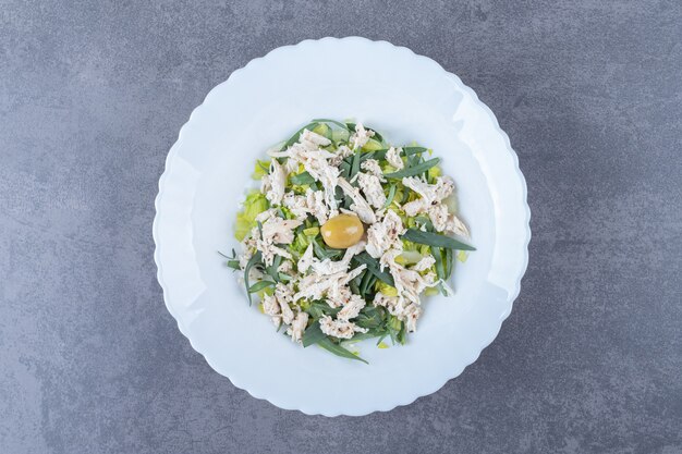 Sliced chicken salad on white plate.