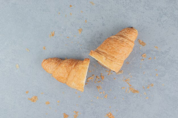 Sliced chocolate croissant on the marble background. High quality photo