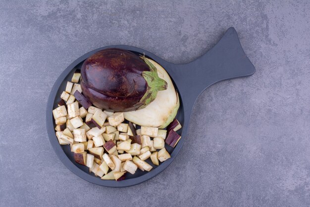 Sliced and chopped eggplants on a wooden board