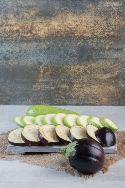 Sliced eggplants and zucchini on wooden board. High quality photo