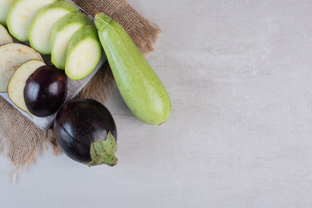 Sliced eggplants and zucchini on wooden board. High quality photo