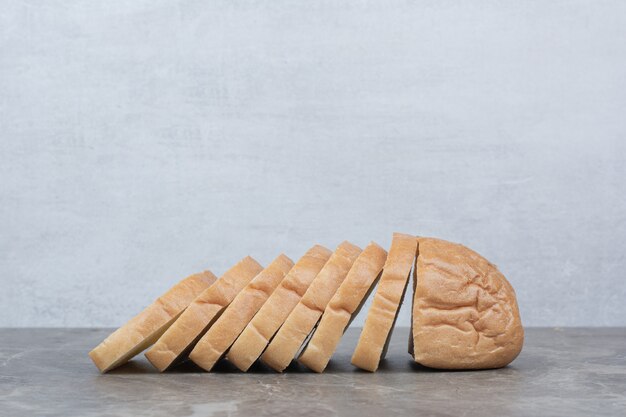 Sliced of fresh bread on marble surface